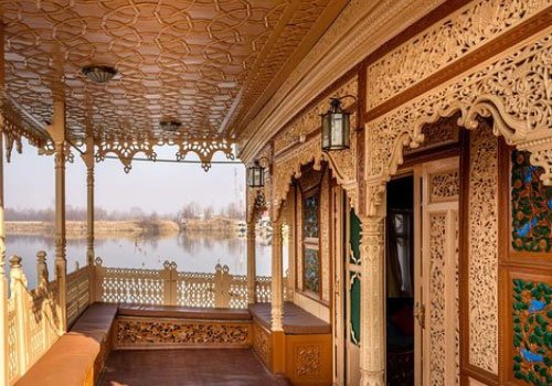 Carved wooden houseboat verandah overlooking Dal Lake