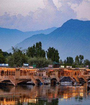 Houseboats lit up on Dal Lake at dusk