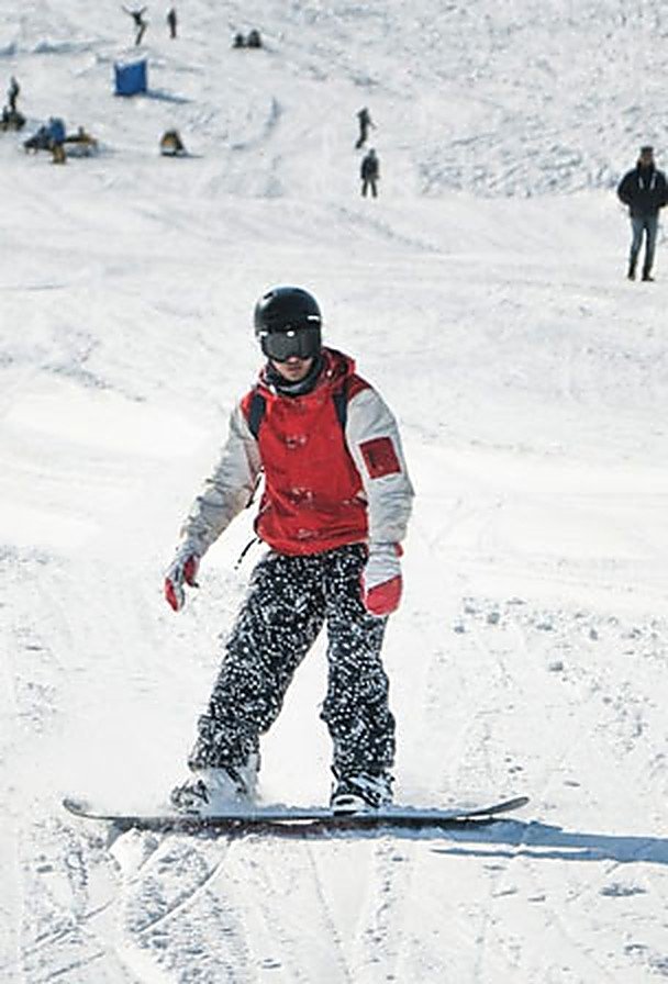 Snowboarder riding the snow at Gulmarg, Kashmir
